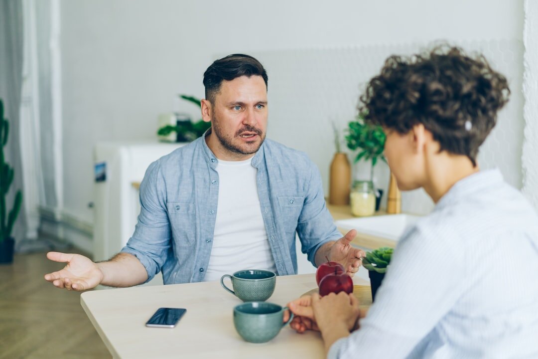 Two people having a respectful calm conversation at a table