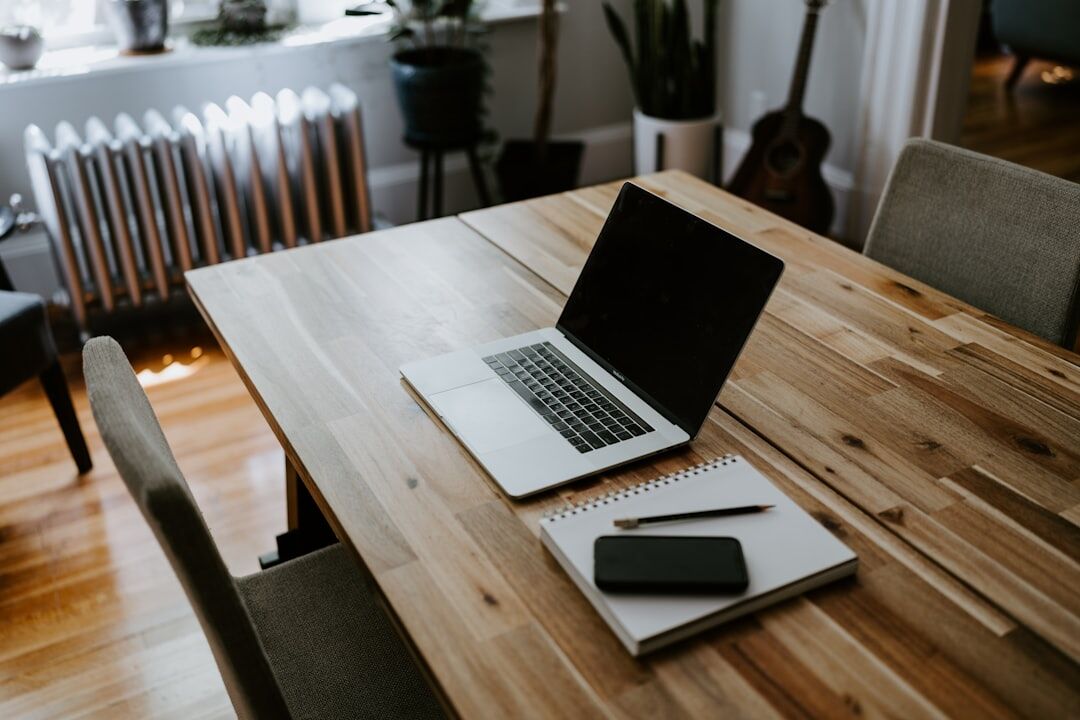Warm home office desk with laptop and notebook