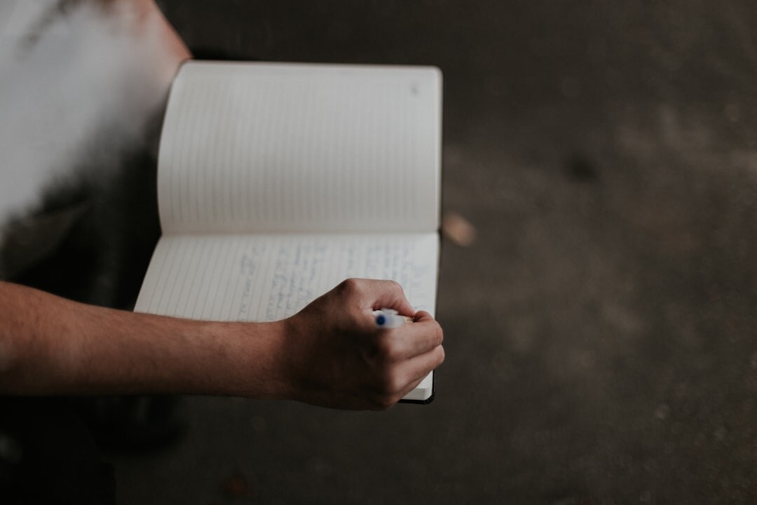person writing in journal