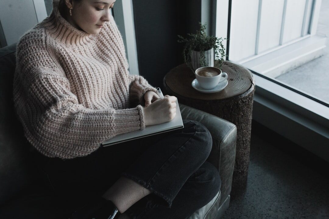 person writing in journal