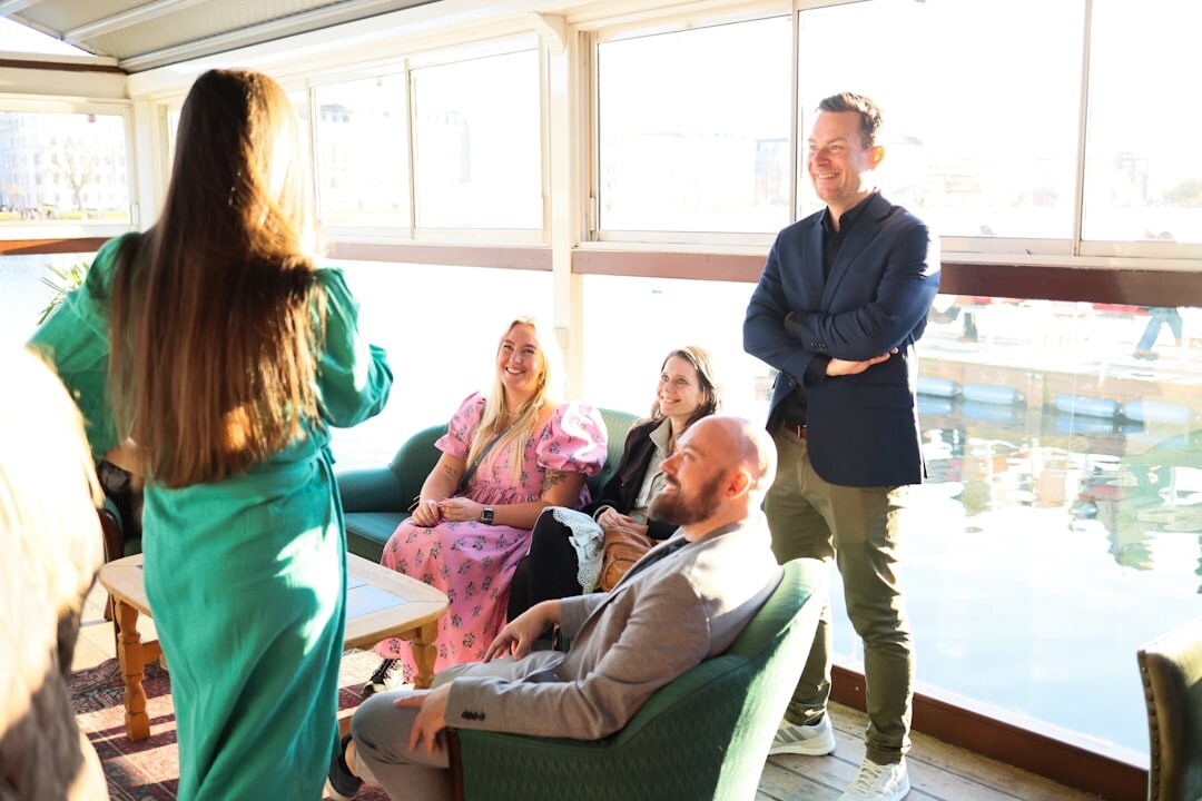 Small group having an open conversation circle indoors