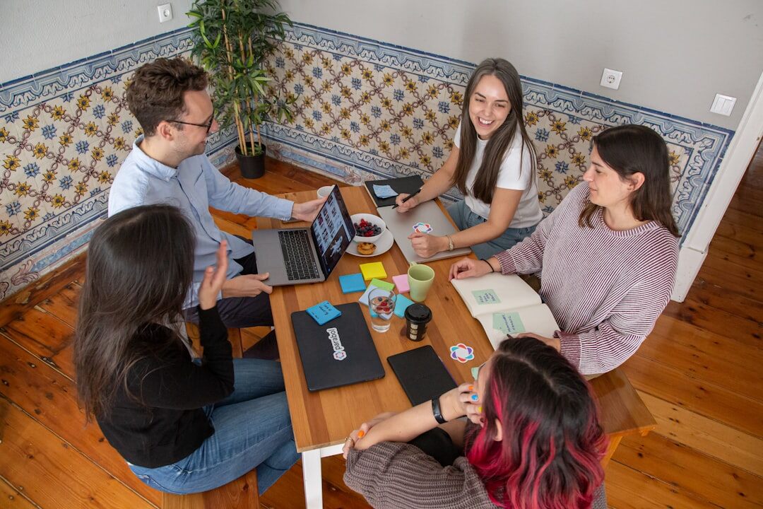 Bright collaborative workspace with people talking around a table