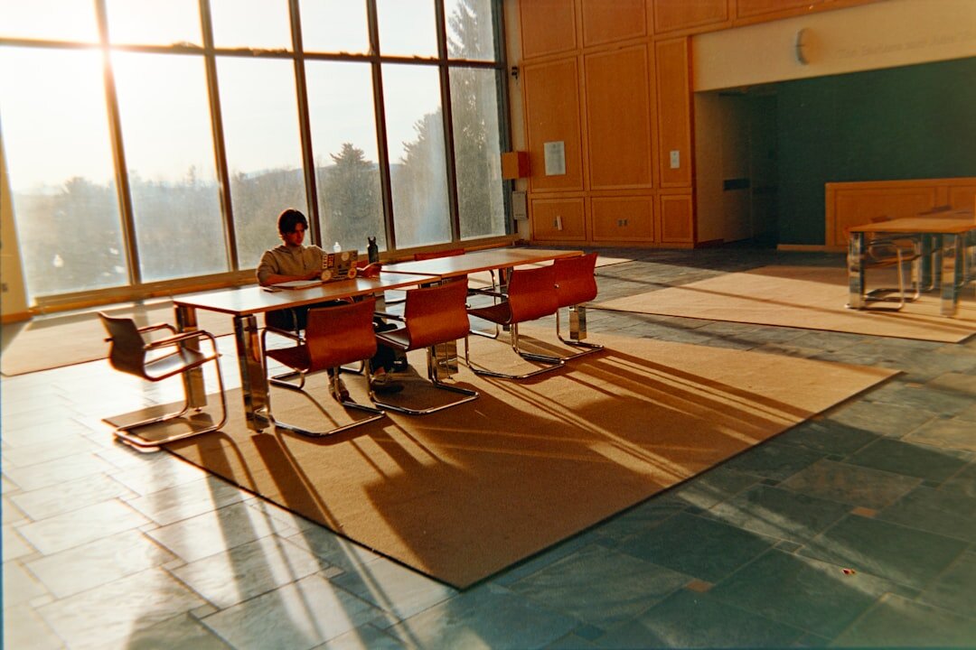 Woman writing in a journal at a sunlit desk